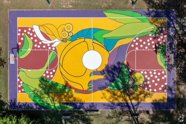 Deerwood Park's basketball court is vibrantly colored with a artistic mural.