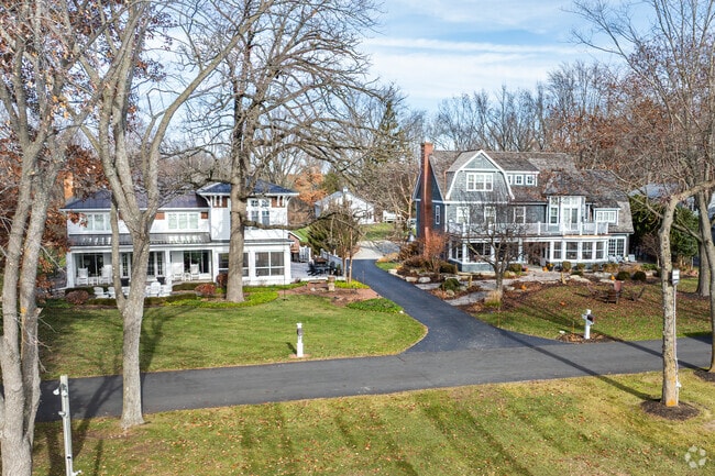 Two and three story mansions sit on long paved streets just off the water in Lac La Belle.
