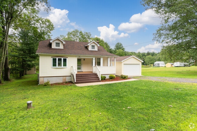 This Cape Cod is settled on a lot of acreage with a detached garage in Dallas.