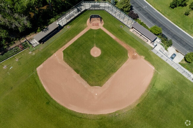 A green and tera cotta colored baseball field at Highland High School.