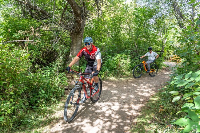 Bikers utilize the trails at Glen Lake Rotary Park near the Northeast neighborhood.