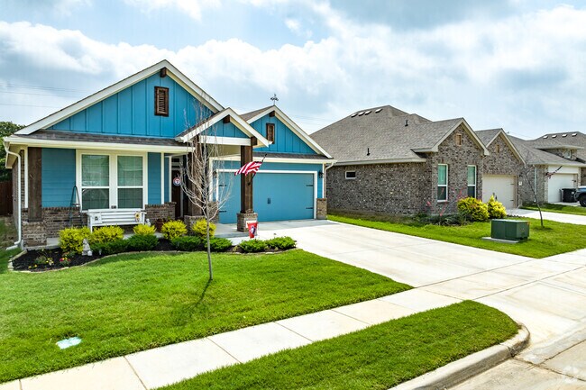 A creatively painted home sits among natural colored brick homes in Pelican Bay.