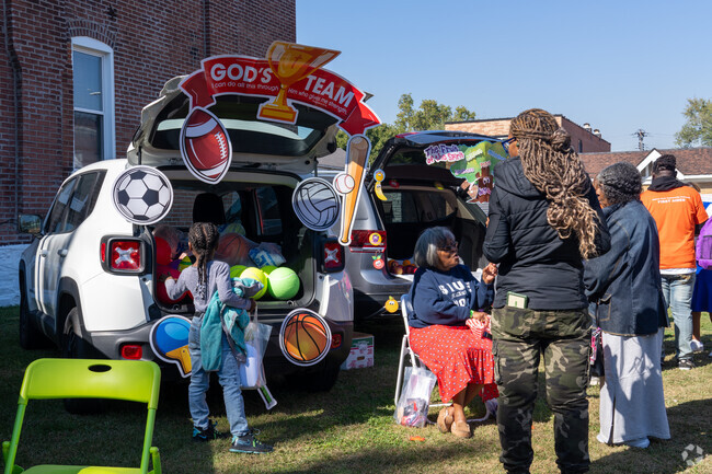 Residents line their cars up and give out treats and trinkets during Fallin' Into Fun.