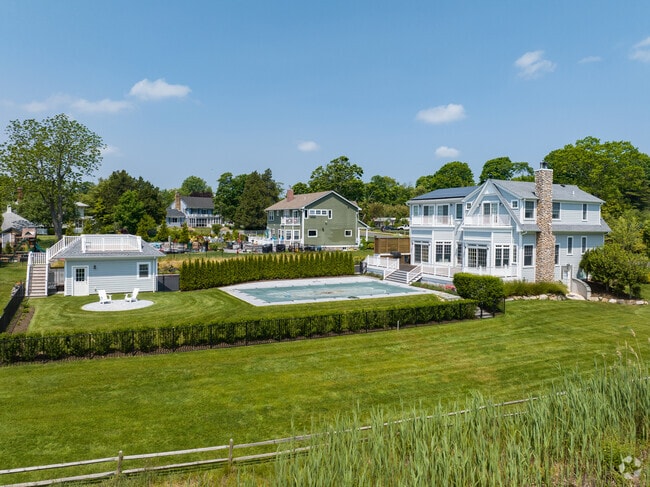 Gorgeous colonial homes with built-in swimming pools line the streets of East Moriches.