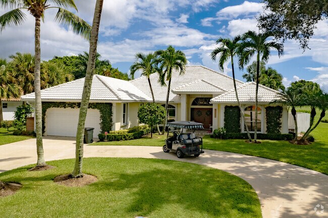 Palm trees frame many ranch-style homes in Ballenisles.