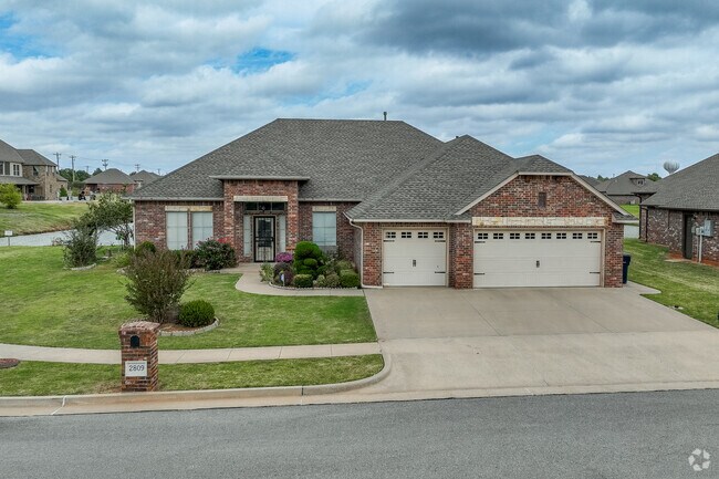 Single story brick home with a large side yard and water view in Southridge-Shadowlake.