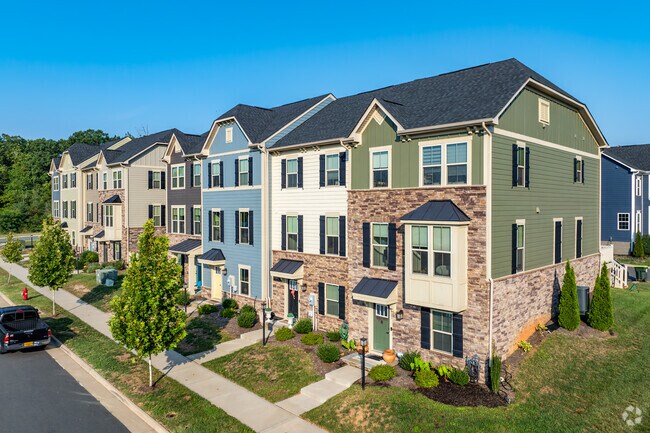 The townhomes in Rivanna feature mixed materials, like stone, siding and wood shingles.