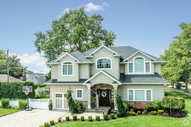 Newly constructed colonial style houses often feature lush greenery in North New Hyde Park.