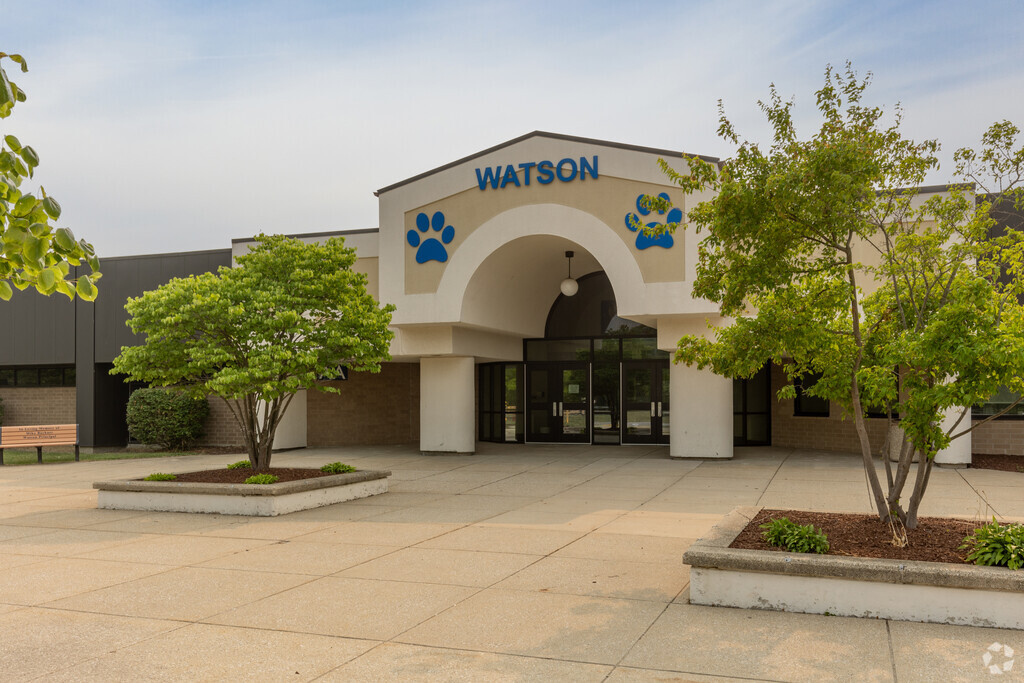 Entrance James H Watson Elementary School flanked by trees and places to sit, Schererville, IN.