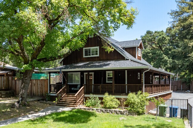 This Craftsman-style cabin in Ben Lomond features rich wood siding and a full wraparound porch.