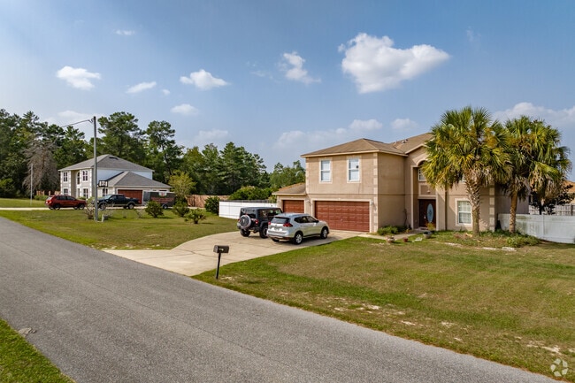 A charming row of two-story homes with attached garages lines the streets of Liberty, showcasing a harmonious blend of style and functionality.