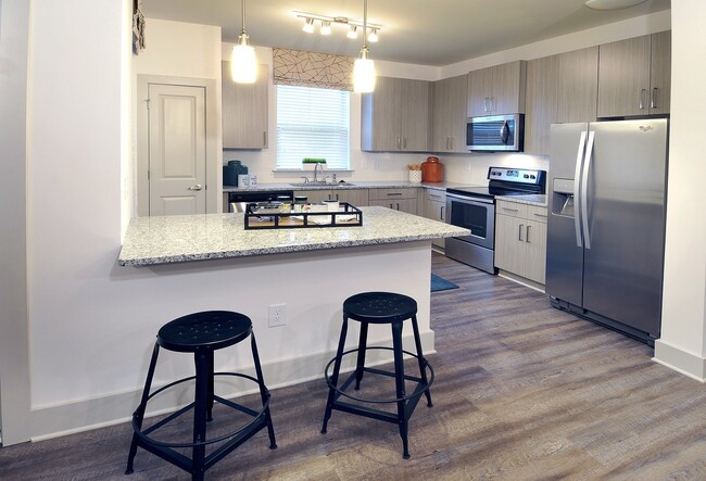 Stunning kitchens include granite countertops and stainless steel appliances