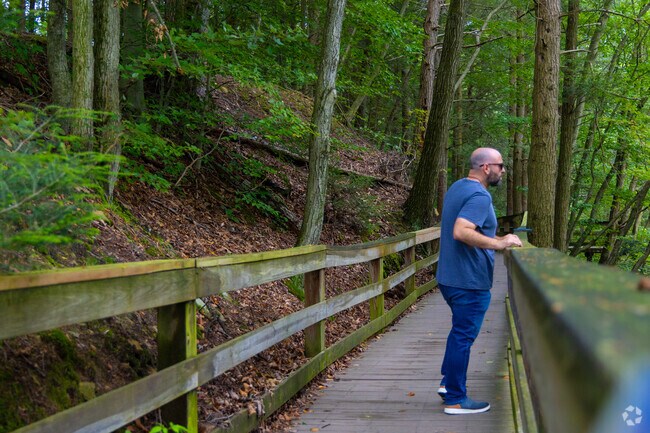 A wooden bridge crosses the Craig Morgan Walking Trail in Sweet Arrow Lake Park.