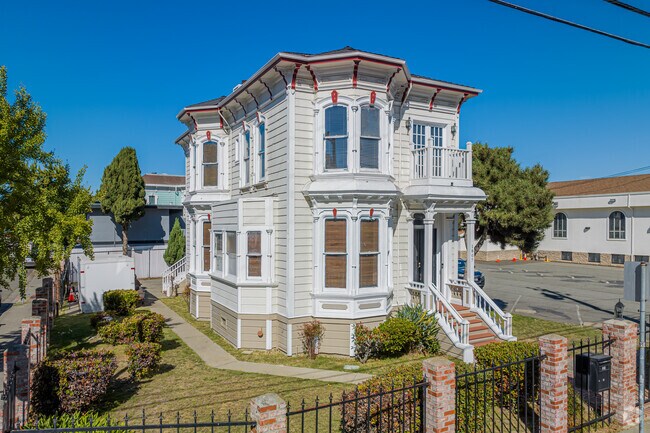 An old white Victorian home with a large yard in northern San Pablo Gateway.