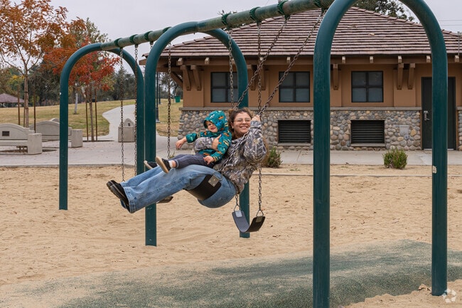 A Terra Vista mother has a good grip while swinging with her son.