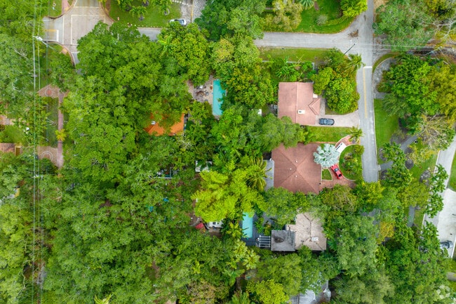 Top-down aerial of homes with pools and lush greenery in El Portal.