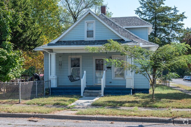A swing on the front porch of this Deming School home is the perfect place to enjoy a book.