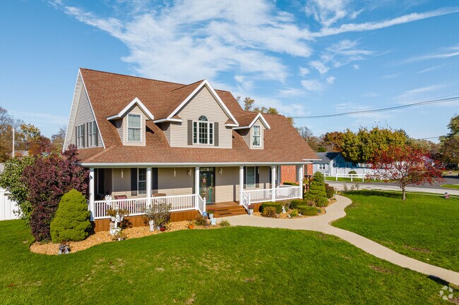 Large farmhouse homes with wrap around porches sit on Rensselaer's quiet streets.