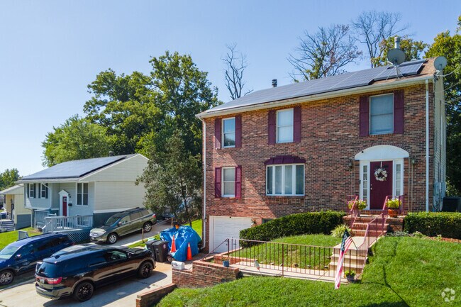 An older brick colonial home next to a rambler on E Kilmer St in Greater Landover.