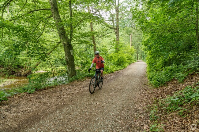 A friendly cyclist poses for a photos along the trail at White Clay Creek Preserve.