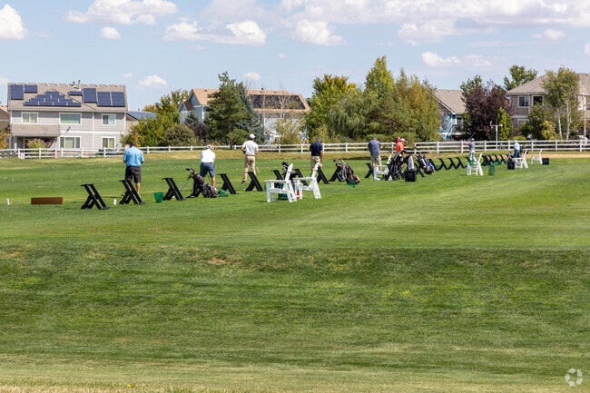 Golfers warm up at the Murphy Creek Golf Course driving range.