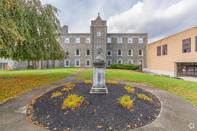 A statue of a book is seen outside the Cumberland Public Library at the former Monastery.