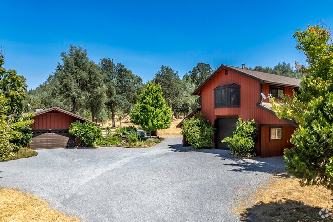 This larger custom-built home has a large lot in the forested area of Mountain Gate.