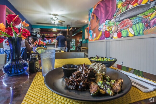 The only thing more colorful than the mural on the wall at Afrodisiac in Milneburg is the food.