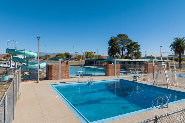 Locals go down the waterslide or jump off the diving board at Mansfield Park's community pool.
