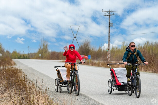 Bicyclists in Big Lake offer a welcoming wave to visitors in the neighborhood.