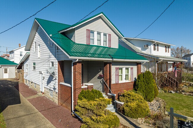 A bungalow with a private drive is set in a south-facing orientation along this Scottdale street
