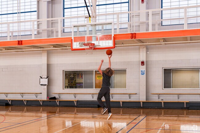 A young Downtown Massillon resident shoots hoops at the Massillon Recreation Center.