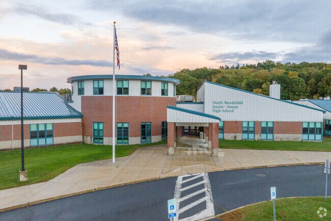 The sun sets behind North Brookfield High School in North Brookfield.