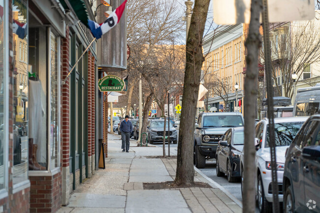 A person strolls down Main Street in Bennington passing many shops.
