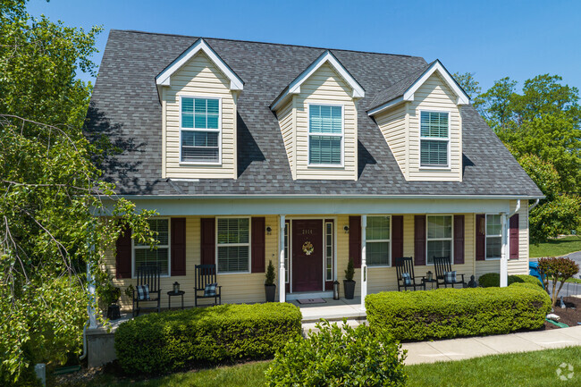 Many Colonial homes in Roselle feature neatly landscaped shrubs and trees.