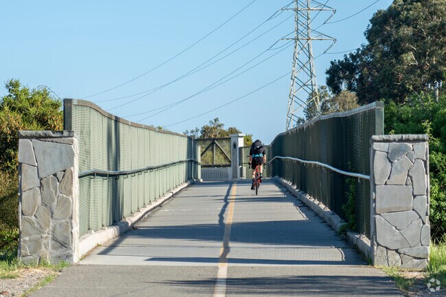 A biker jumping on the bridge of the Stevens Creek Trail.