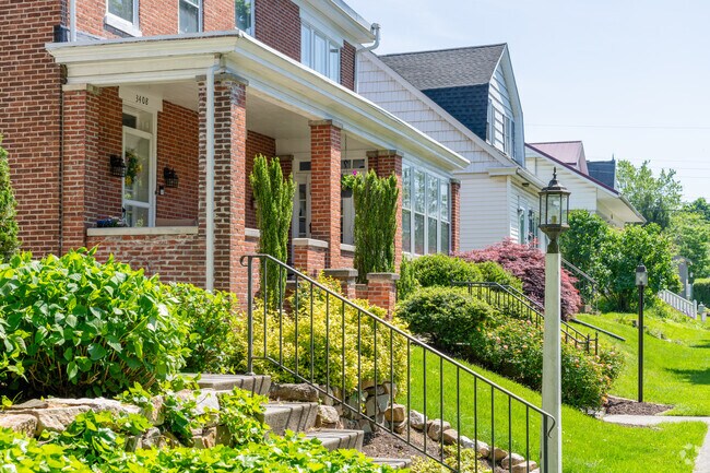 Quaint homes in Paxtang sit on small hills with porches and sidewalk lamp posts.