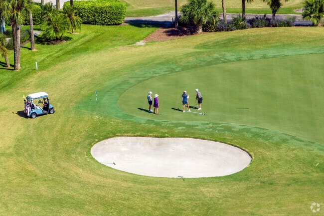 A foursome enjoys a round of golf on the Sugar Mill private golf course.