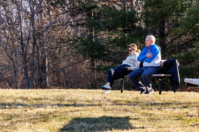 Couples enjoy views from the top of the sledding hill at Lakewood Forest Preserve.