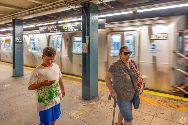 Commuters heading into NYC start the trek west at the 63 Dr-Rego Park subway station.