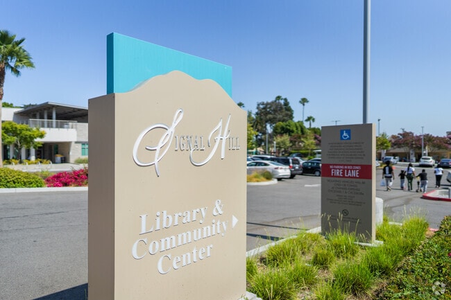The modern library and community center sits near the old civic center building in Signal Hill.