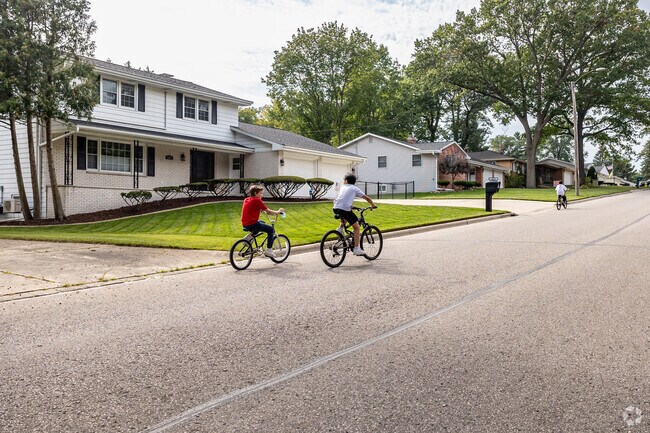 Kids ride their bikes through the John Muir Park neighborhood.