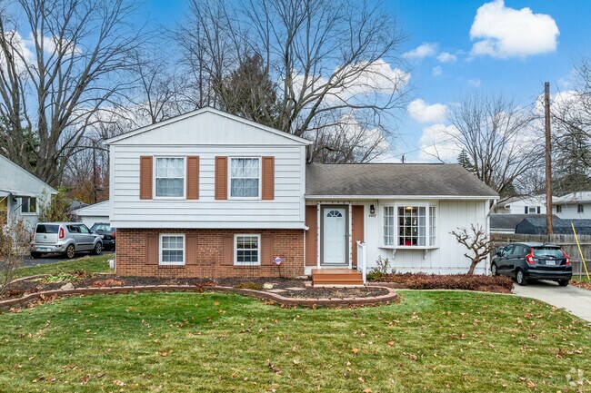 Split level home in Clinton Estates features beautiful landscaping.
