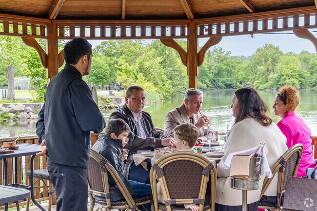 The Stone House at Clove Lake Park offers outdoor seating with a beautiful lake view.