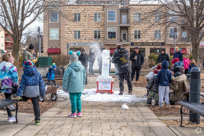 Families watch in awe during a live ice carving during Frozen Fest in Cannery Square.