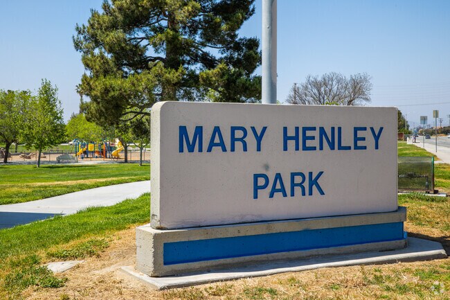 Tall pines and green grass can be seen at Mary Henley Park in Hemet.