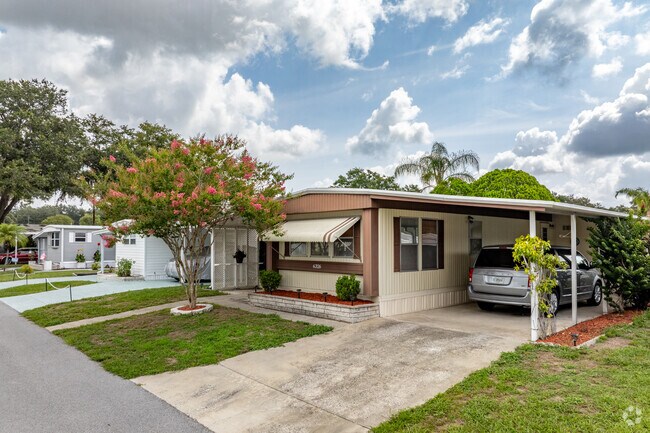 Zephyrhills North features well-kept manufactured homes with private driveways and carports.