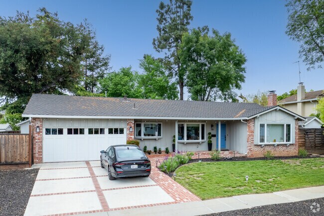 This updated Ranch-style home in Glenview Serenity blends brickwork with fresh landscaping and a bold entry.