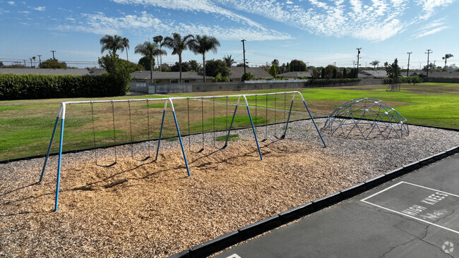 Swings and an expansive grass field are found at College View Elementary School in Goldenwest.