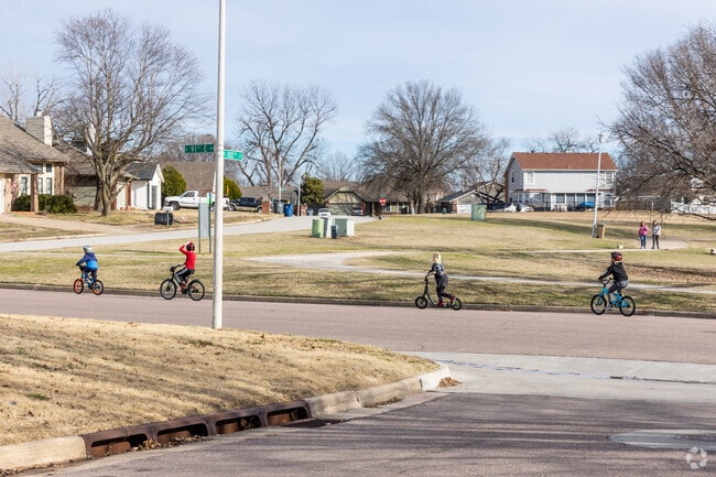 Kids ride bikes through the streets of Cedar Ridge.